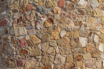 Old beige stone wall background texture close up