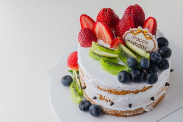 Fresh fruit homemade cake with Happy birthday tag,