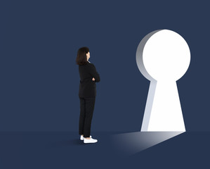 Obraz premium Woman standing in front of a huge keyhole