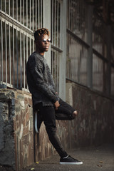 Obraz premium Fashionable stylish african american man wear torn jeans in urban territory