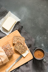 Loaf of rye bread with butter and cup of coffee. Space for your text. Breakfast.