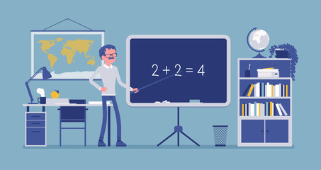 Male teacher stands at the blackboard