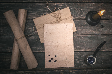 Blank letter page and feather pen on wooden desk of author background.