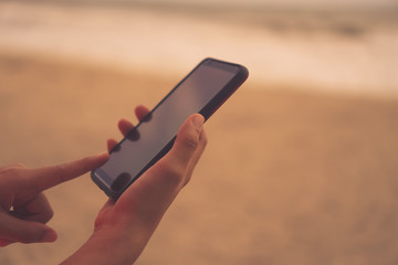 Woman hand using smartphone.