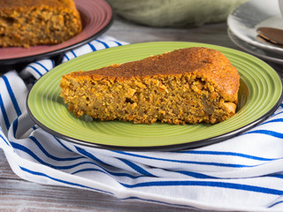 Spiced carrot cake with walnuts and cinnamon with breakfast setting background