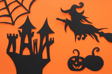 Halloween holiday concept. haunted witch house over orange background. Top view, flat lay.