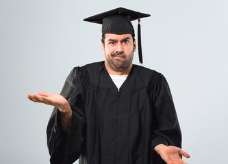 Man on his graduation day University unhappy and frustrated with something because not understand...