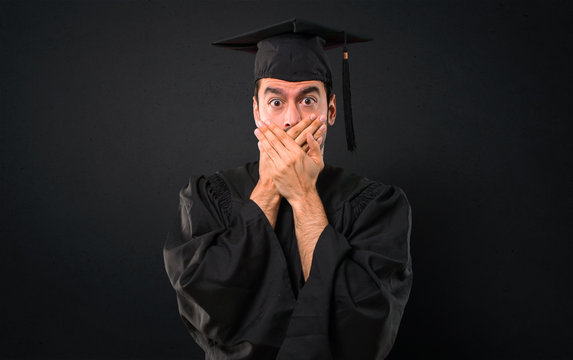 Man On His Graduation Day University Covering Mouth With Both Hands For Saying Something Inappropriate. Can Not Speak On Black Background