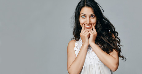 young woman pulls a smile. Concept about mental problems