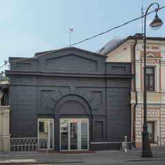 Fototapeta na wymiar Black facade of old historic building in the street of city