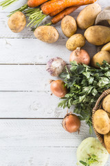 Potatoes onion carrot celery kohlrabi and garlic.