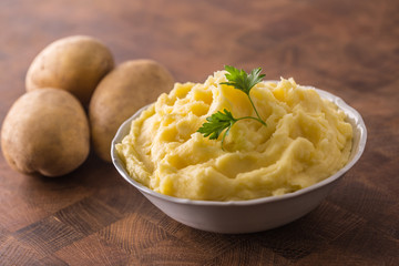 Mashed potatoes in bowl decorated with parsley herbs