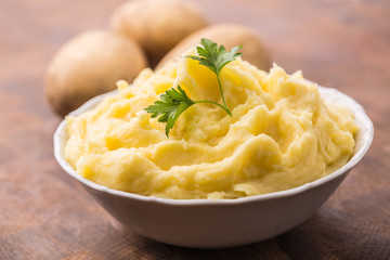 Mashed potatoes in bowl decorated with parsley herbs