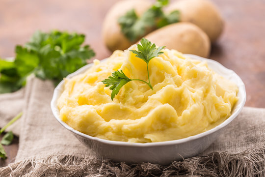 Mashed potatoes in bowl decorated with parsley herbs
