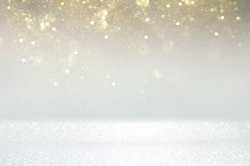 glitter vintage lights background. silver, gold and white. de-focused.