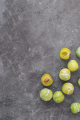 Delicious ripe green plums Greengages Black textured concrete background Autumn harvesting Flat lay Copy space