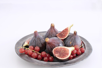 Ripe organic red currant Figs Ceramic plate Isolated white background background Still life Copy space Autumn harvest