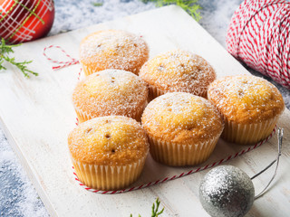 Christmas baking concept - muffins with icing sugar and festive winter decorations