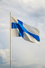 Flag of Finland on a blue sky with clouds background