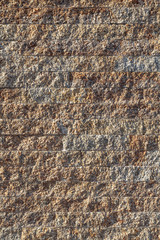 Old beige stone wall background texture close up