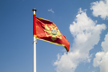 Flag of Montenegro against blue sky