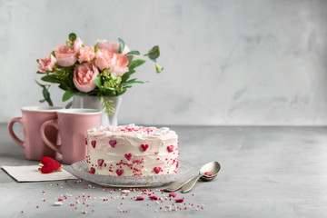 Cake with small hearts and colorful sprinkles on a plate with  two cups of coffee. Grey stone background. Romantic love background banner. Valentine's day, Mother's Day, Birthday Cake card.