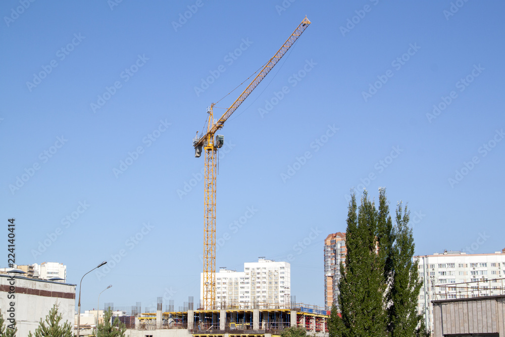 Poster example of point construction in a residential area. crane on the site of the building under constru