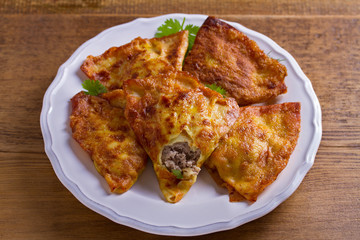 Savory stuffed crepes with meat. Pancakes filled with meat