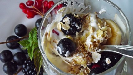 Delicious dessert in a glass.Cereals from the five cereals with yoghurt,banana and fresh berries.
