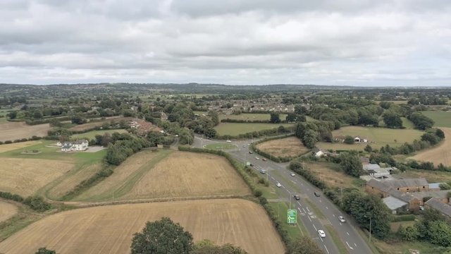 Aerial view, tilt down move. Busy roundabout from distance,near Tarvin, small town in cheshire.