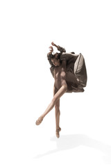 Beautiful slim young female modern jazz contemporary style ballet dancer in silhouette wearing...