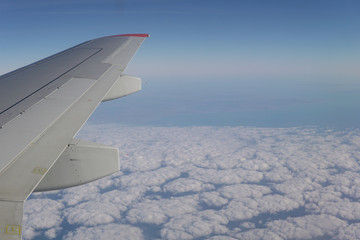 Obraz premium Wing blue sky and clouds in the journey