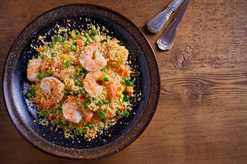 Shrimps with couscous, green peas, leeks and carrot. overhead, horizontal