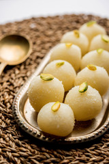 Indian Rasgulla or dry Rosogulla dessert/sweet served in a bowl. selective focus