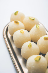 Indian Rasgulla or dry Rosogulla dessert/sweet served in a bowl. selective focus