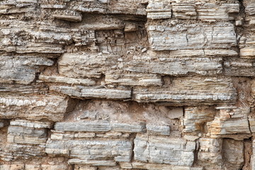 Close up of details of abstract natural stone rock cut texture cross section of weathered granite cliff erosion. Crack, hard.