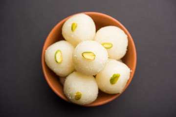 Indian Rasgulla or dry Rosogulla dessert/sweet served in a bowl. selective focus