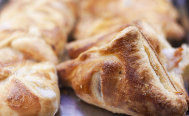 Close up freshly baked puff pasty from the oven in bakery shop