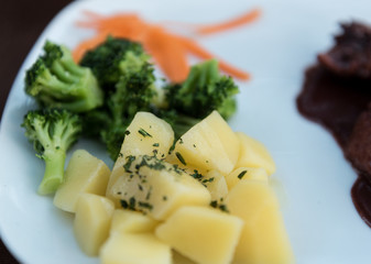 
potatoes, broccoli and carrot on a plate