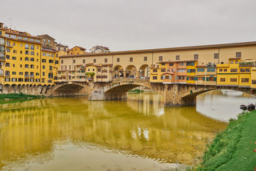 Famous bridge "Ponte Vecchio" at cloudy day in Florence in Italy