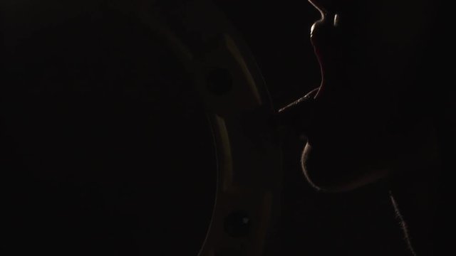 Mad woman warrior, licks the blade of her weapon