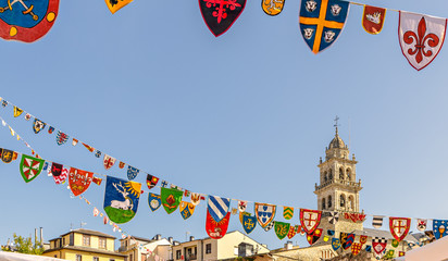 Colorful strips of pennants decorate the sky in the Spanish city of Ponferrada during local festivity.