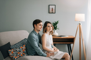 Free time together. Happy beautiful couple is spending weekend together at home, relaxing and enjoying the company of each other. man and the woman embrace.