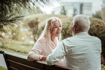 Fototapeta premium Love this talks. Pleased female person demonstrating her emotions while spending time together with husband