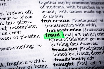 Fototapeta premium Close Up of Highlighting Specific Word Fraud in a Dictionary