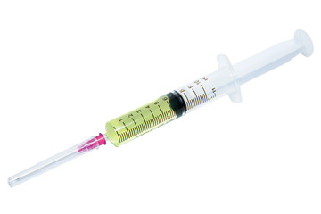 Fototapeta premium Plastic syringe with yellow liquid on white background.