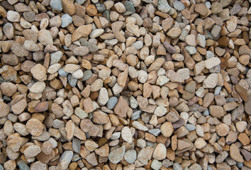 Stone pebbles brown and gray gravel texture background for decoration.