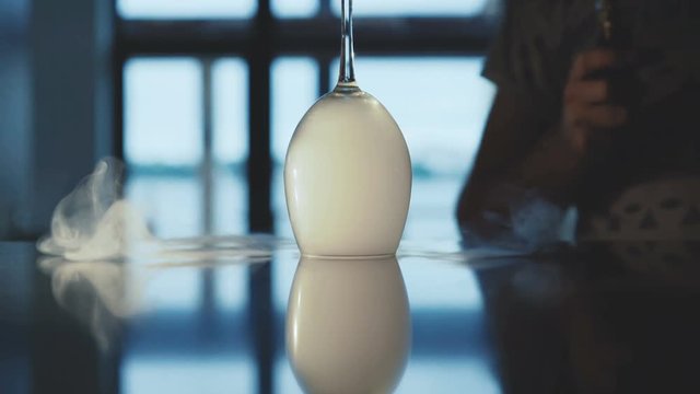 Man smoke toxic vapor from under the moving goblet