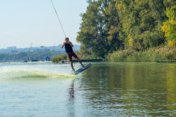 Wakeboarder is flying behind the cable