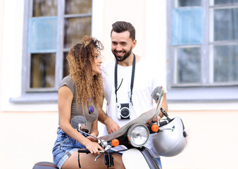 Fototapeta na wymiar Scooter ride. Beautiful couple riding scooter together.